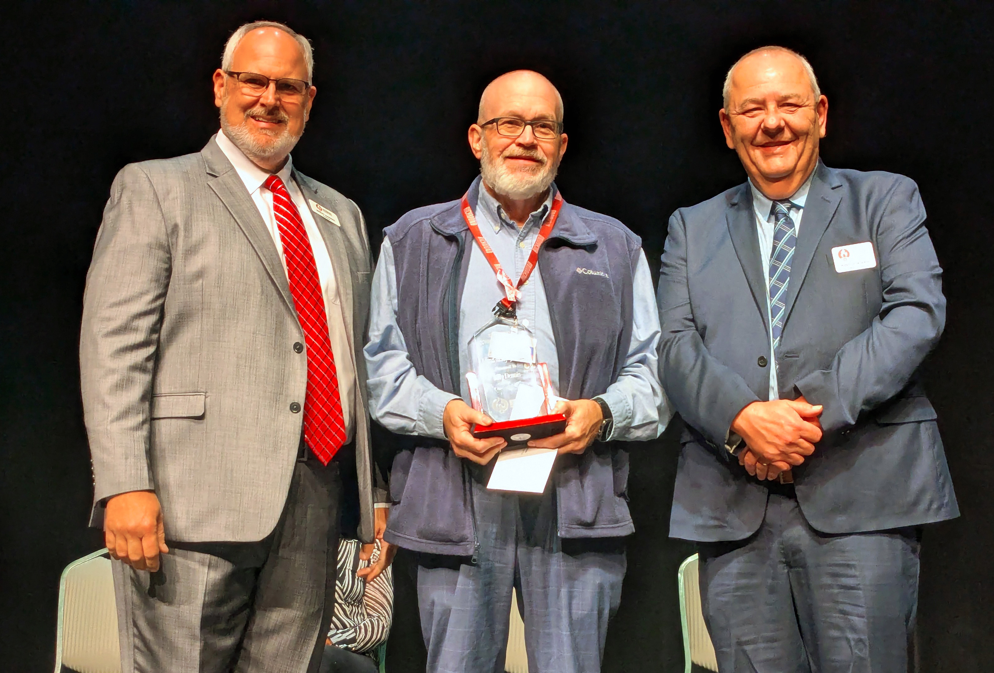 Billy Dennis accepts his award on stage.