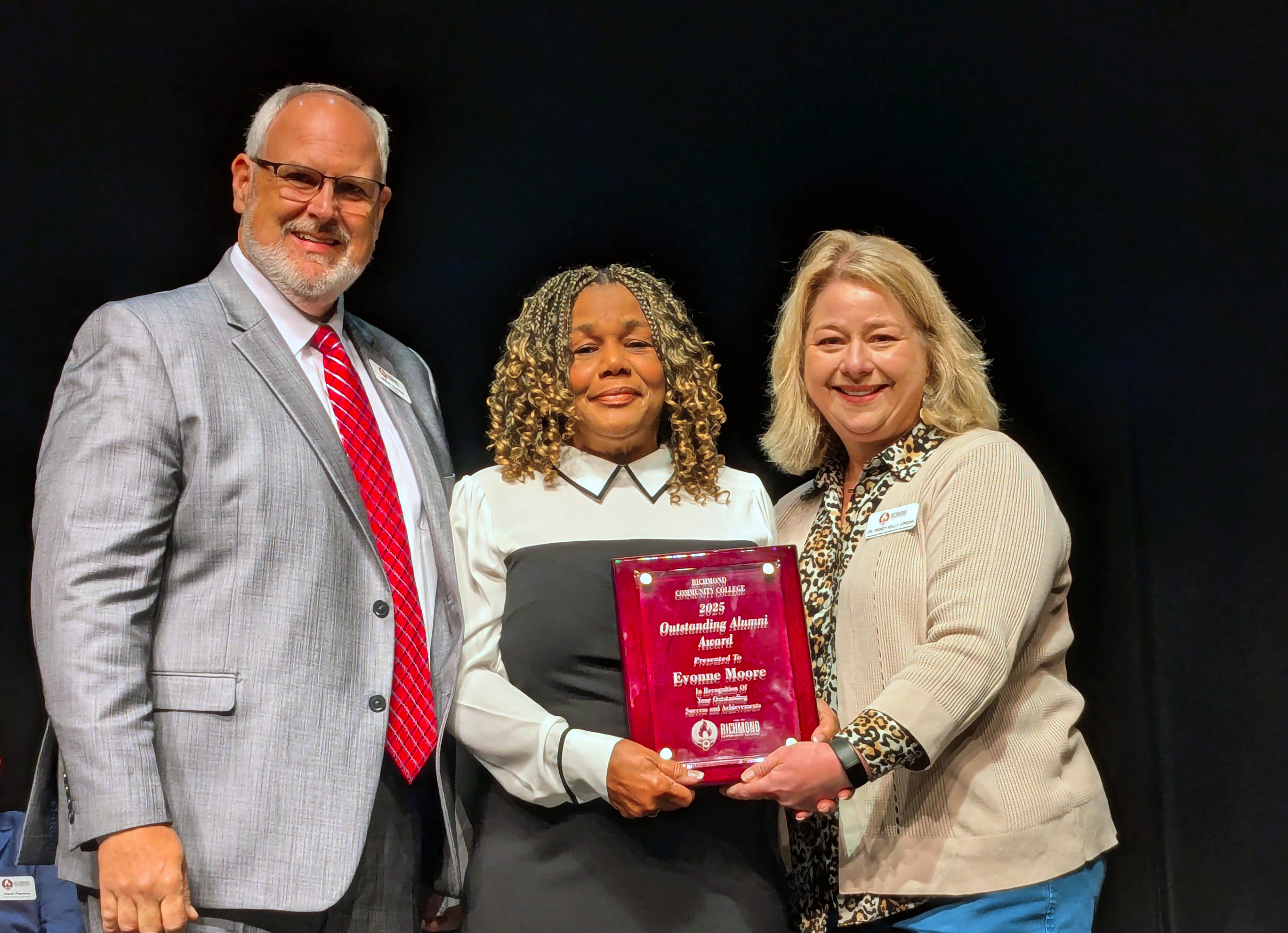 Evonne Moore accepts her award on stage.