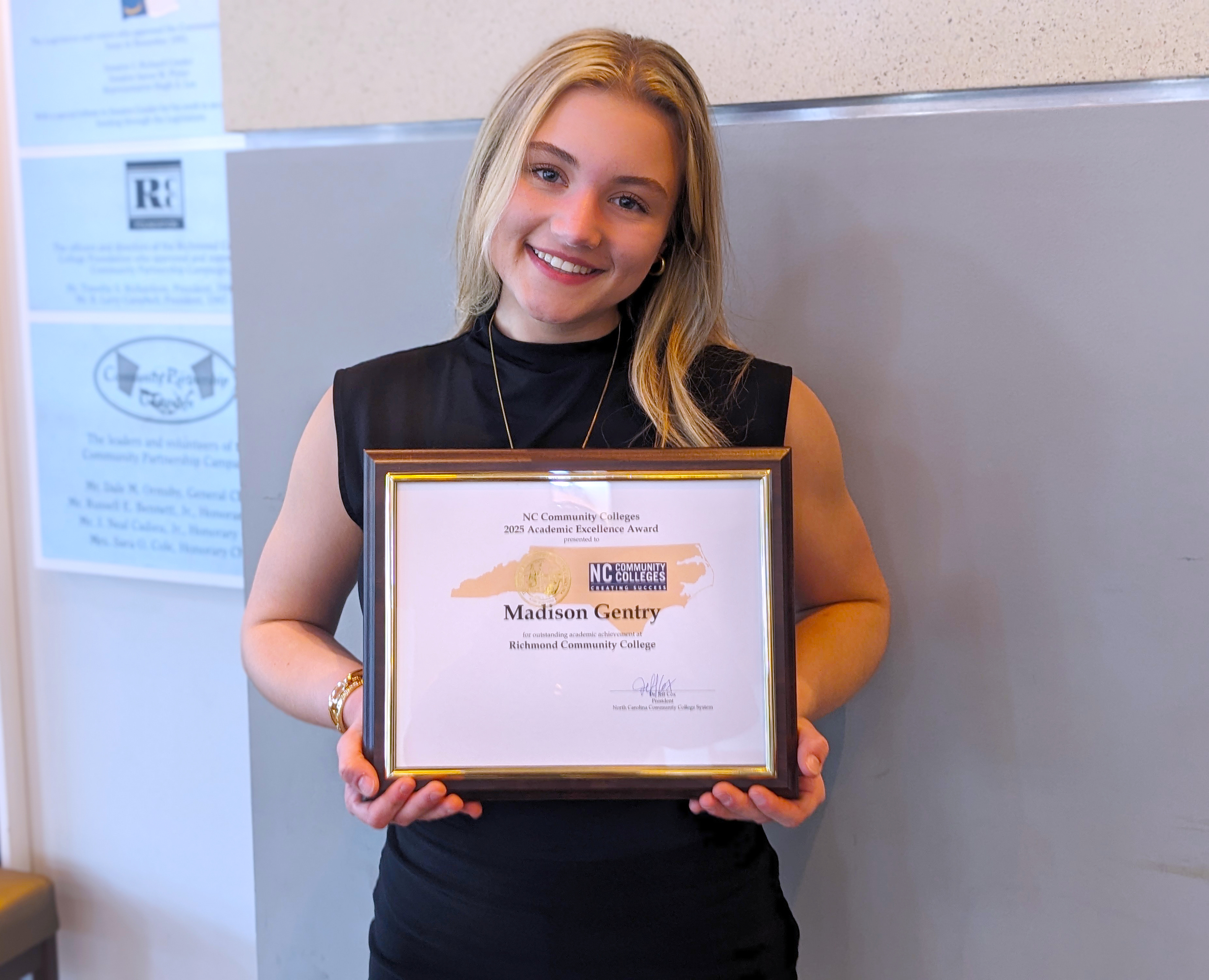 Madison Gentry holds her Academic Excellence Award